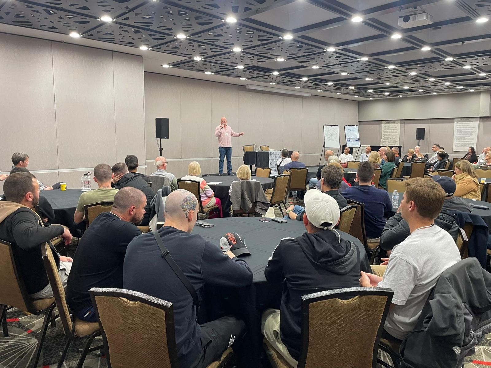 Speaking to a full room at a recovery event